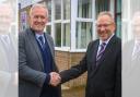 Mike Cloherty (left) is congratulated by current headteacher Simon Goodwin (right) after being appointed his successor at South Wirral High School