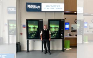 Mersey Ferry terminal staff member Rob Wynn shows off the new self-service kiosks