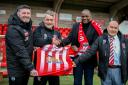 Witton Albion manager Jon Macken, kit man Paul Houghton and director Julian Jackson present a kit to Kasupe founder Davy Chilakalaka