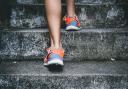 Orange running shoes, running up stairs