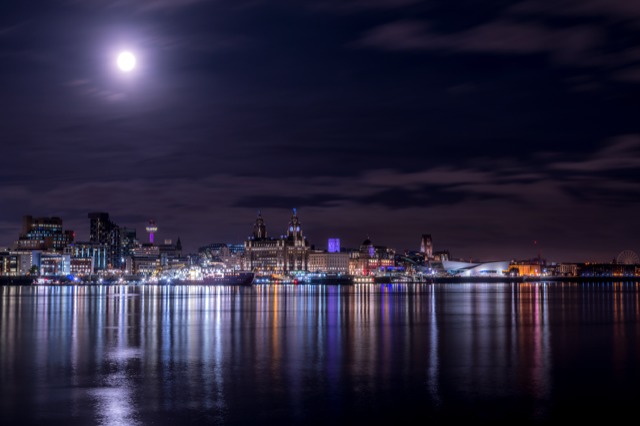 Moon glowing over the Mersey while the Liverpool lights shine 