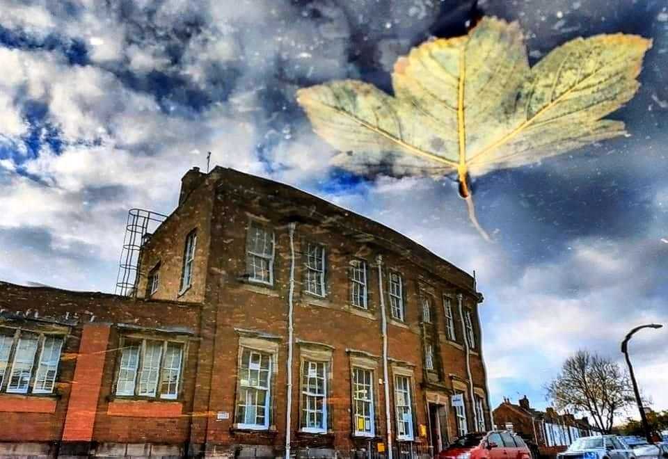 Puddle reflection of Liscard post office by Kimberley Phillips