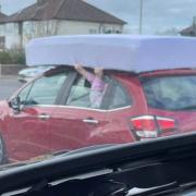 WATCH: Bizarre moment as driver clings on to mattress while driving in Leasowe