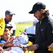 Tommy Fleetwood stops to meet young fans during his practice round at Royal Liverpool