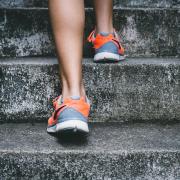 Orange running shoes, running up stairs