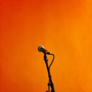 Microphone with orange background.