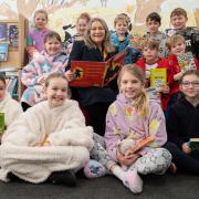 Bellway sales advisor Pauline surrounded by children from Greasby Junior School