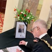 Wirral's Mayor and Mayoress signing the Book of Condolence opened in tribute to former MP Frank Field