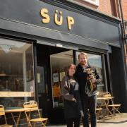 Scott Duffy and Luce Barrett with their dog Pip at SUP. Credit: Ed Barnes
