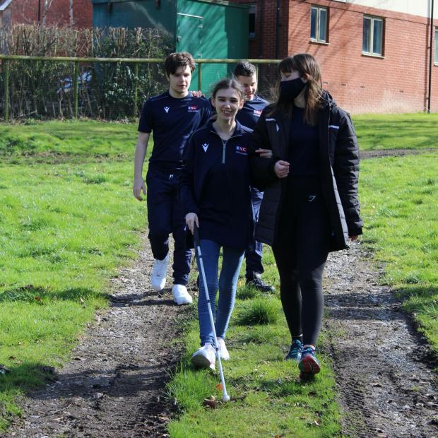 Wirral Globe: Nicole (left) taking part in a training walk with her sighted guide, Nele, accompanied behind by fellow students George Williams (left) and Jay Stallard (right)