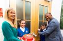 John Barnes, head teacher Coleen Hibbard with fantastic red velvet cake, complete with LFC crest, and pupils at New Brighton Primary School sports hall opening. Picture: Cal Hibbard