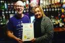 Pub manager Helen Duffy being presented the award by Wirral CAMRA