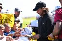 Tommy Fleetwood stops to meet young fans during his practice round at Royal Liverpool