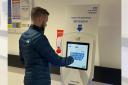 New digital check-in screens are being installed at Arrowe Park and Clatterbridge Hospitals in a bid to cut waiting times