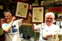 Lenny (left) and Mike Henry celebrate with their awards behind the bar at The Lazy Landlord. (Picture: Steve Regan)