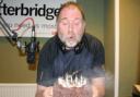 Vic Charles blows out his candles