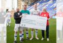 Joe Murphy from Tranmere Rovers Football Club with Steve Davey and Terry Evans of West Kirby School and College presenting donation cheque to Lesley Crombie from Save the Children