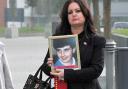 Donna Miller, with a photo of her brother Paul Carlile, arrives at Birchwood Park, Warrington, Cheshire for the opening of the inquest into the Hillsborough disaster