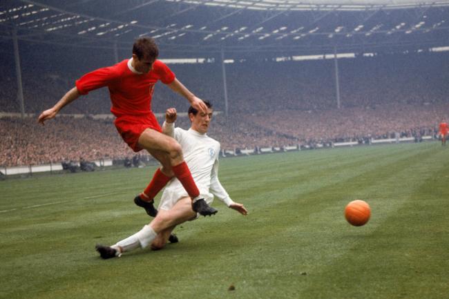 Leeds United's Norman Hunter (r) slides in too late to prevent Liverpool's Roger Hunt (l) firing the ball across. Photo: PA