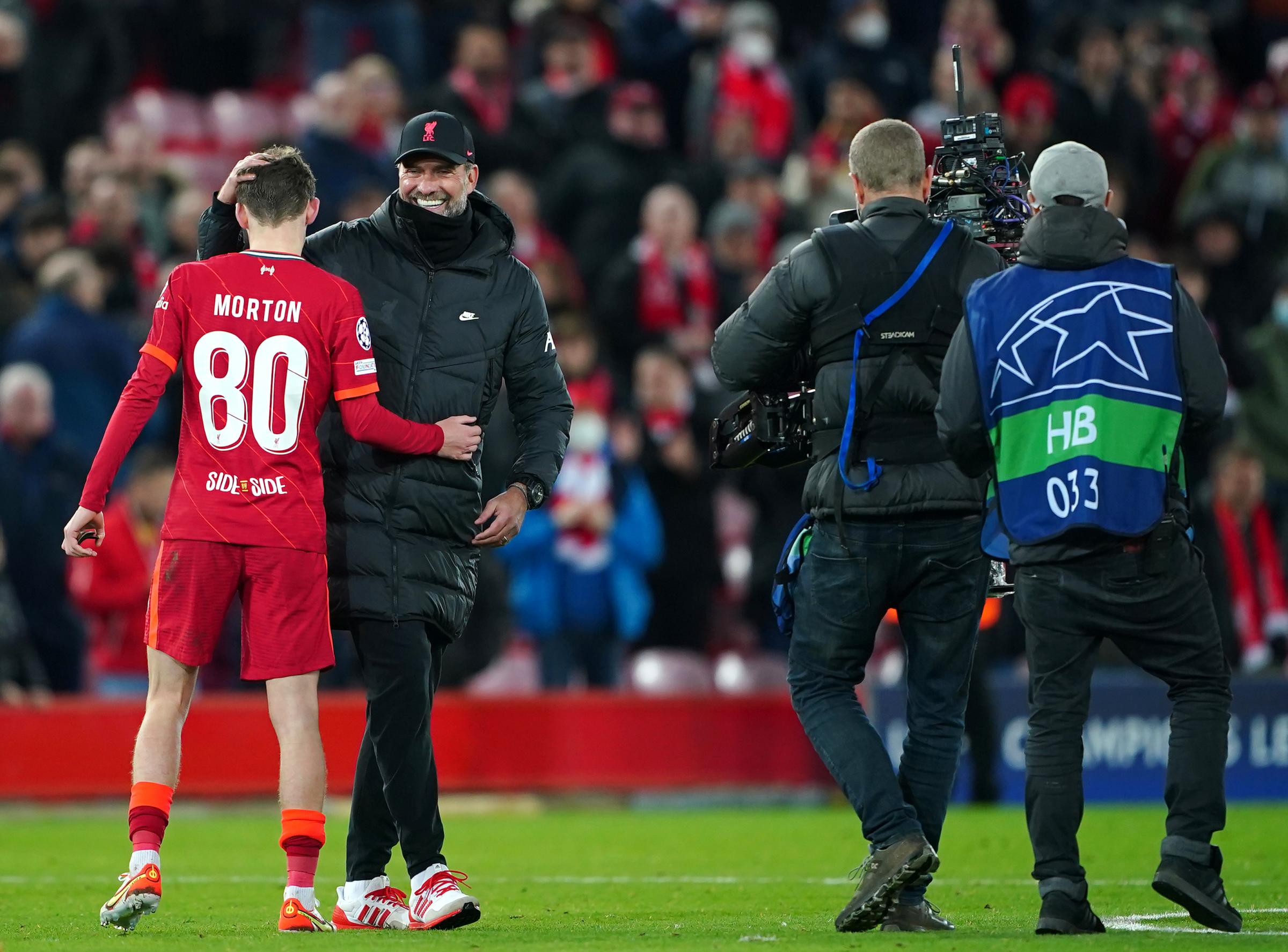 Liverpool manager Jurgen Klopp (right) greets Tyler Morton after the final whistle during the UEFA Champions League, Group B match against Porto at Anfield. Photo: Peter Byrne / PA