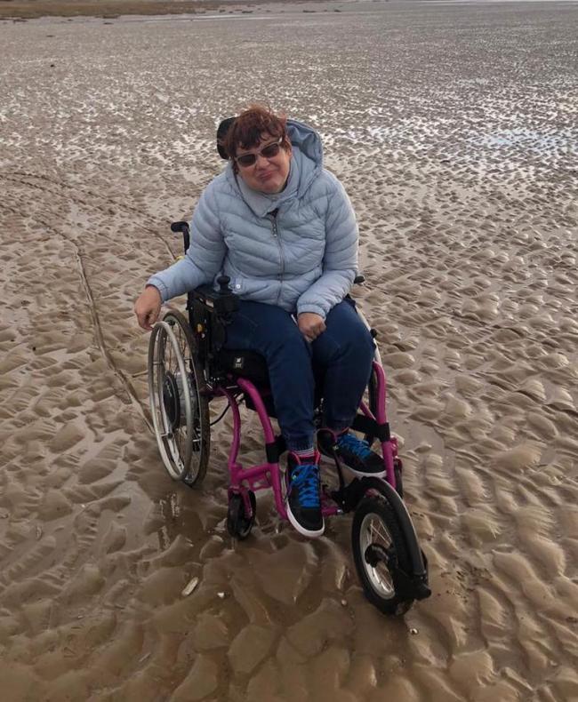 Pippa Bellis in her new wheelchair on Hoylake beach