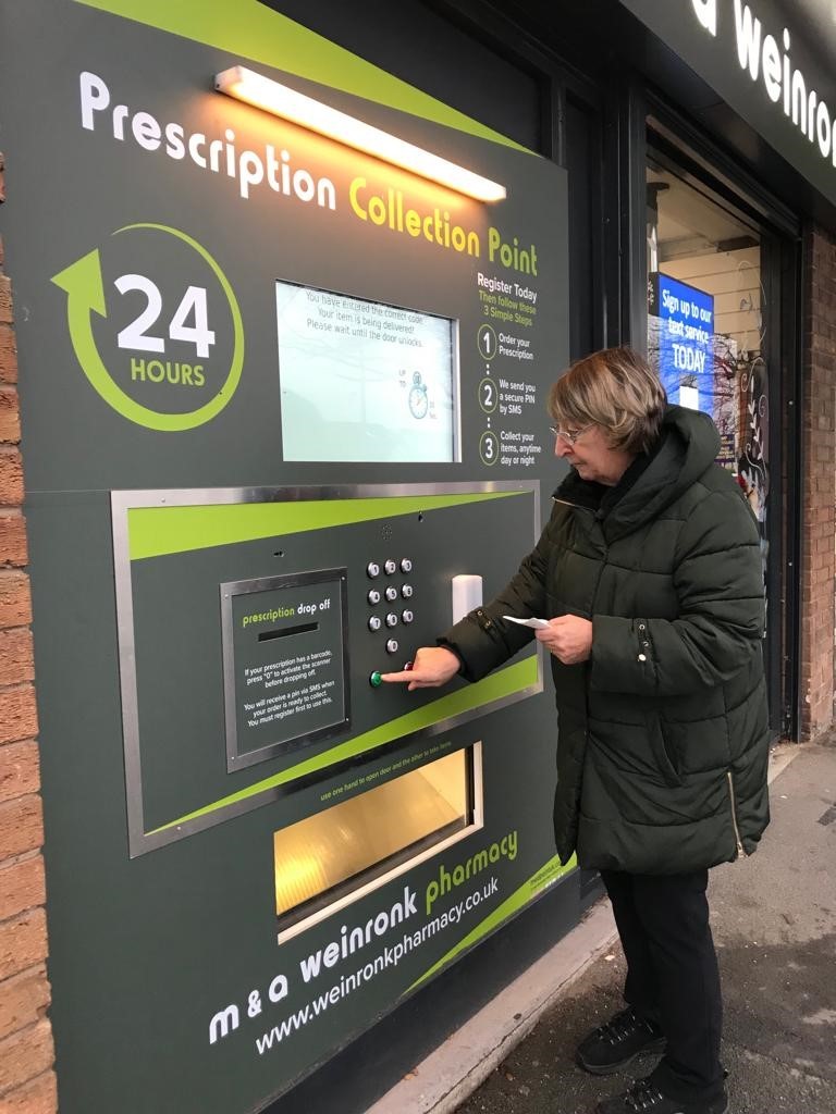 A customer uses the new prescription machine for the first time