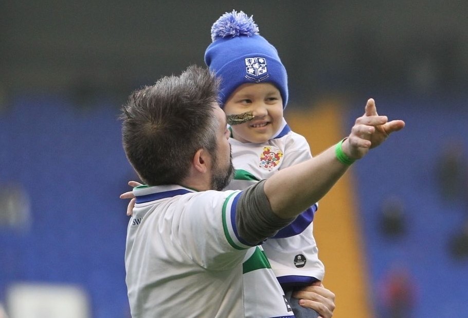 Proud dad Phil shows a beeming young Nate the strength of the Super White Army. Photo: Tranmere Rovers