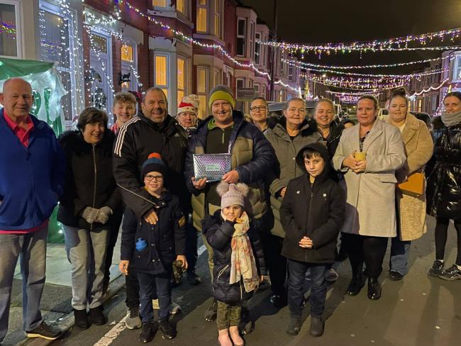 Caleb's family is presented with the £1120.10p by Billy Gordon (fourth on left) from  Patterson Street Rainbow Community. Picture by Kevin stock