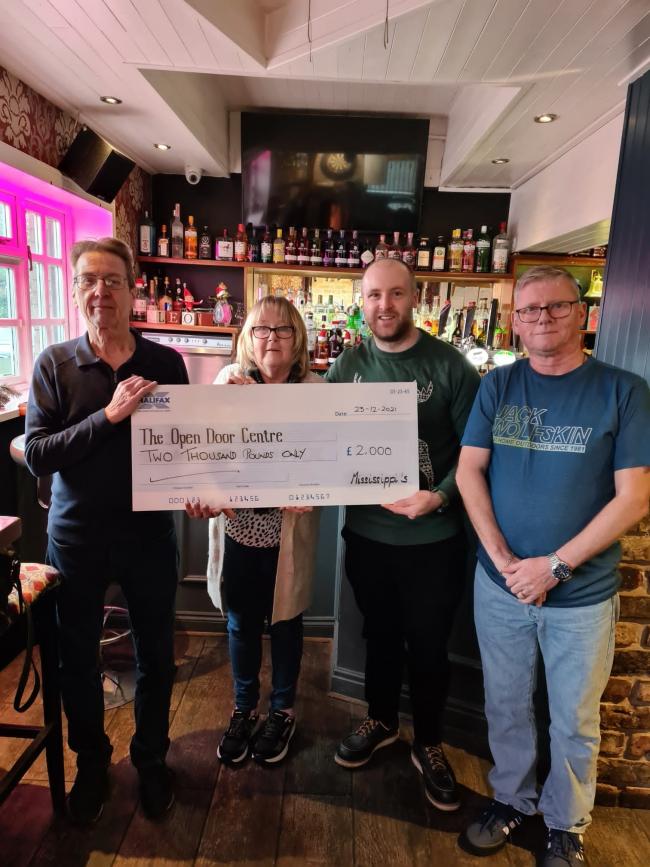 Grey Edwards (second from right) of Open Door Charity, receives the cheque from (left-right) Neil Quinn, owner of Mississippi's and fundraisers Sue & Martin Henderson