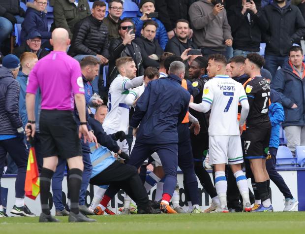 Wirral Globe: A steward takes a tumble amid the confrontation between players and subs