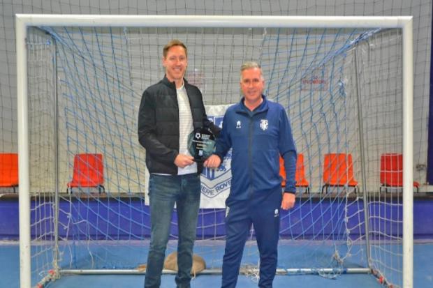 Scott Davies receives his award from  Steve Williams, manager of Tranmere Rovers in the Community