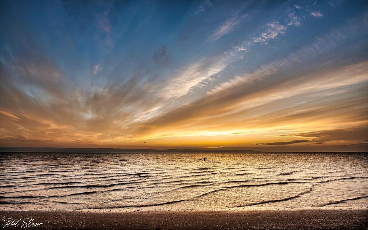 The sun goes down on Caldy Beach by Phil Slessor