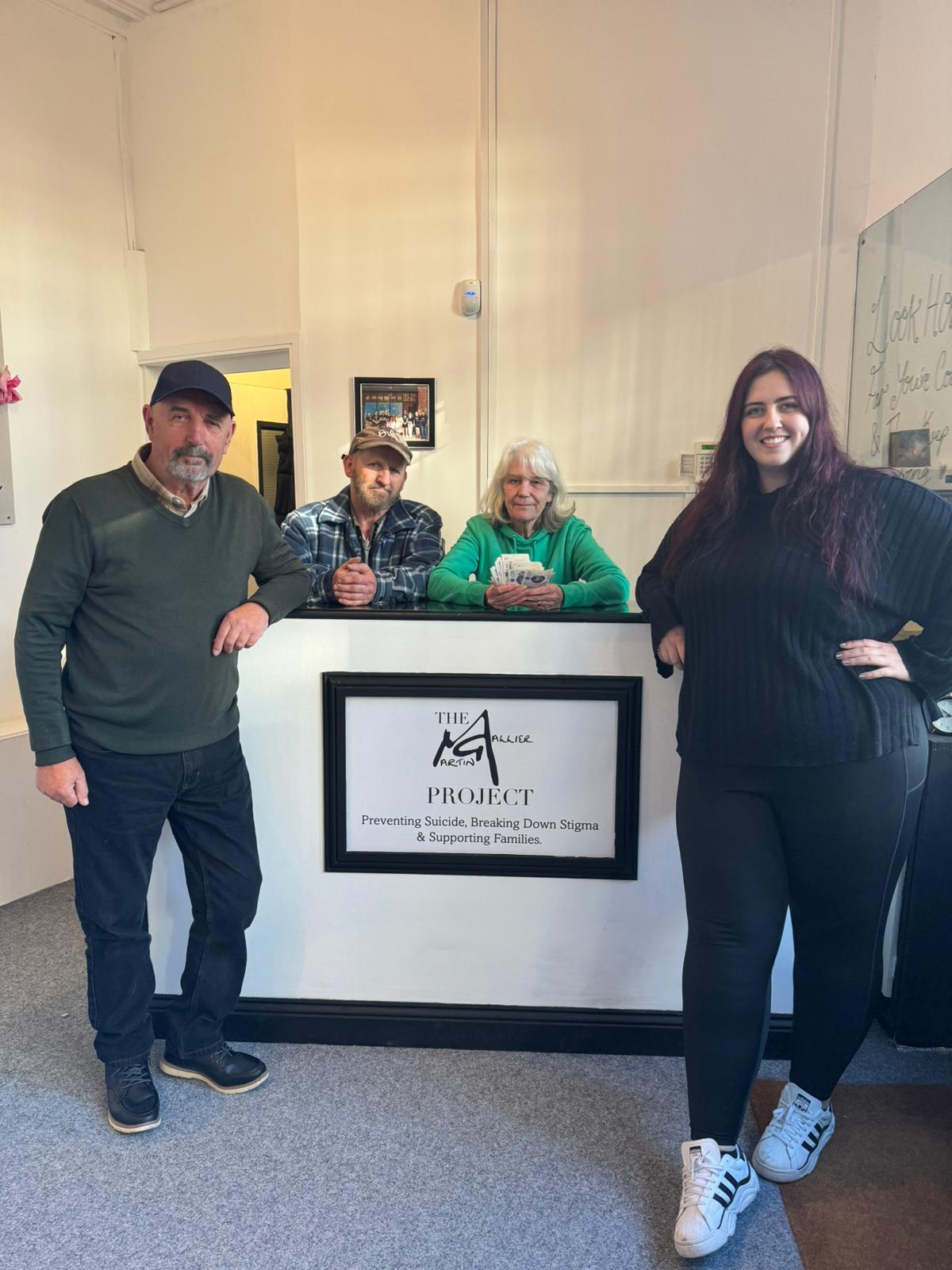 Mick Hughes, John Jennings and Eira Hughes hand over £808 to Georgia Rooney at the Martin Gallier Project Chester.