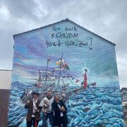 Major Mace, Daniel Davies (archie the dog) and Frank Lund in front of the new mural