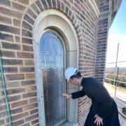 Canon Amaury Montjean examines the church’s windows