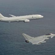 Undated handout photo issued by the Royal Air Force of a P-8A Poseidon and Typhoon overflies Vasily Bykov over the North Sea.