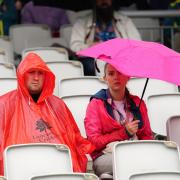Fans shelter from the rain on day five of the fourth LV= Insurance Ashes Series test match at Emirates Old Trafford