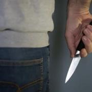 Stock photo of person holding a knife