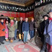 The HEAC group in Ron's Place with Conservation Architect Bernadette Bone, far left, and Martin Wallace, next to the lion fireplace, wearing orange beanie