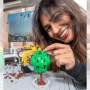 Nisha Katona MBE, chief executive and founder of the Liverpool based Mowgli Street Food group is pictured placing a LEGO brick monkey figure on Clatterbridge Cancer Charity's Big LEGO Brick Hospital in 2018