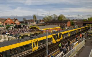 Racegoers travelling to and from The Grand National Festival at Aintree Racecourse by Merseyrail at the weekend